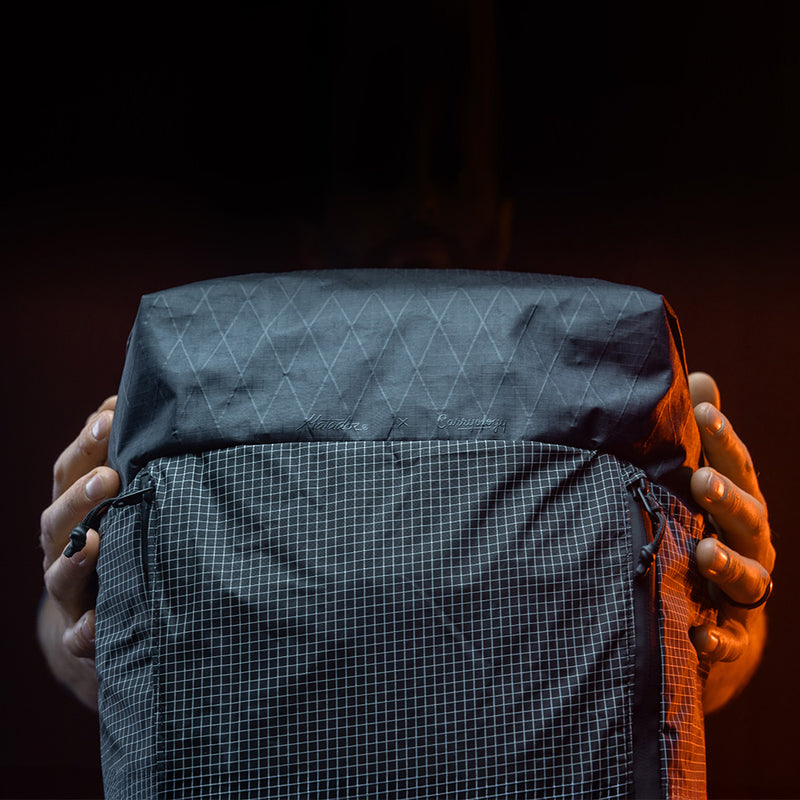 detail view of edx light backpack materials on dark studio background