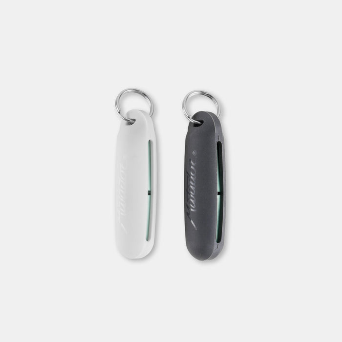 White and black silicone earplug cases laying on light gray background