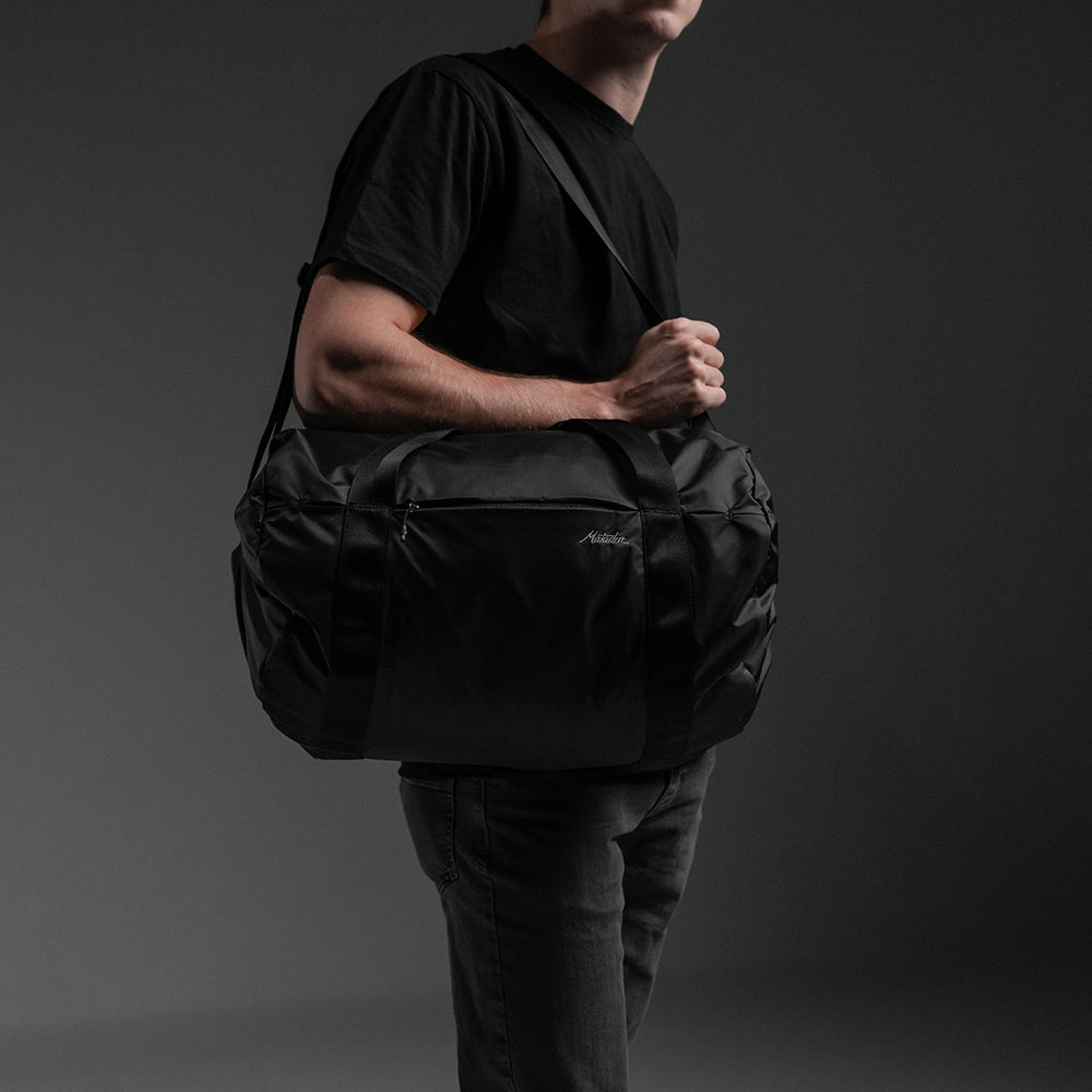 Man on gray background wearing On-Grid Duffle