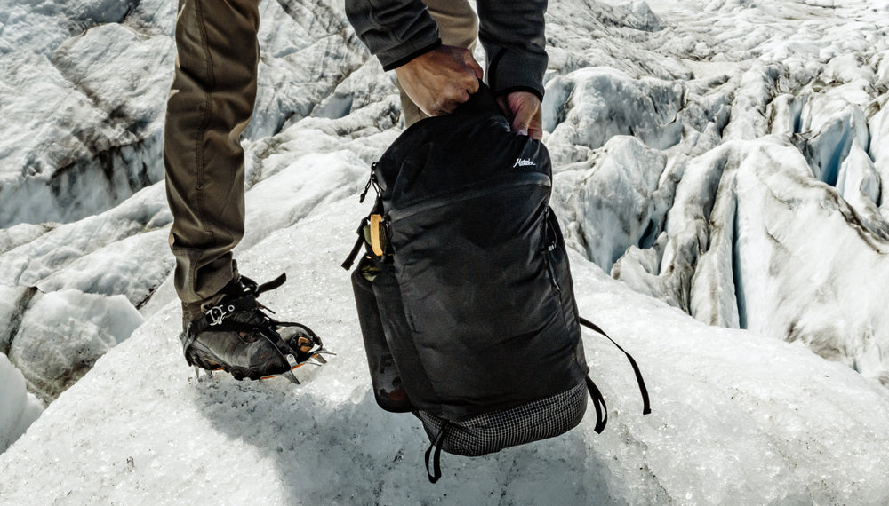 Person wearing crampons on ice field, zipping up Freefly16