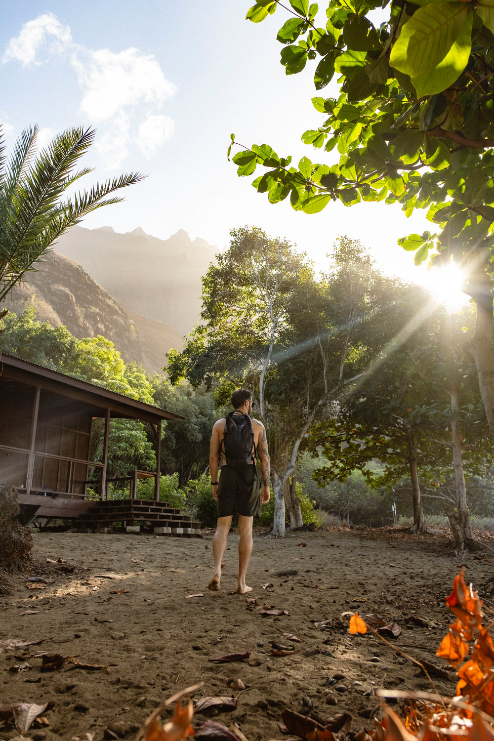 man wearing frerain22 backpack next to hawaiian home