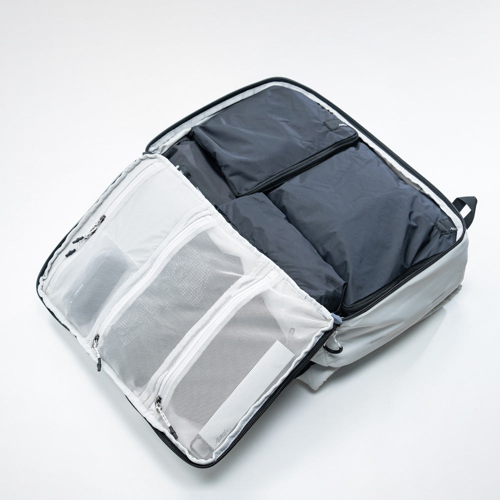 Open clamshell of white globerider35, revealing black packing cubes