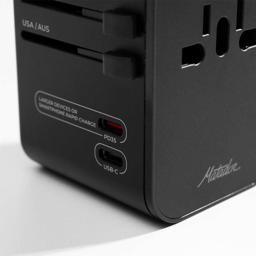 close up view of PD35 and USB-C ports on black travel adapter