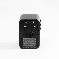 back view of black global travel adapter on white background