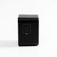 Side view of "press to release" button on black travel adapter, white background