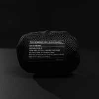 Packed down backpack pouch on black background