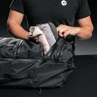 Man placing rolled shirts in zipper compartment of SEG45